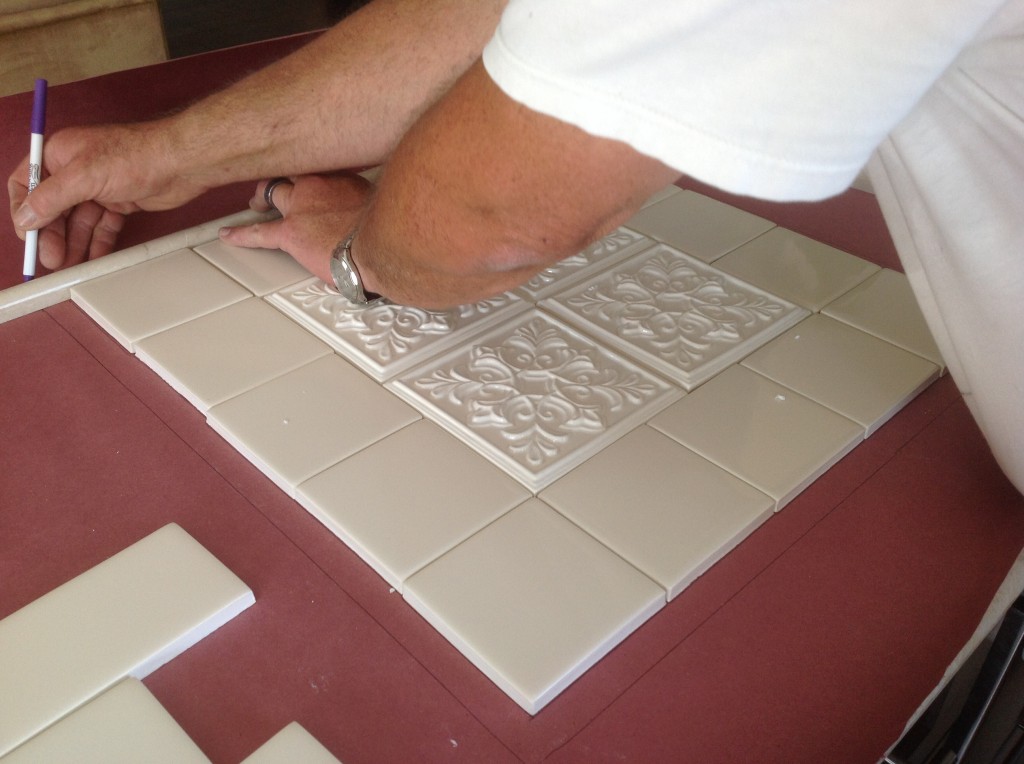 Preparing the framed tiles that will go behind the stove top.  